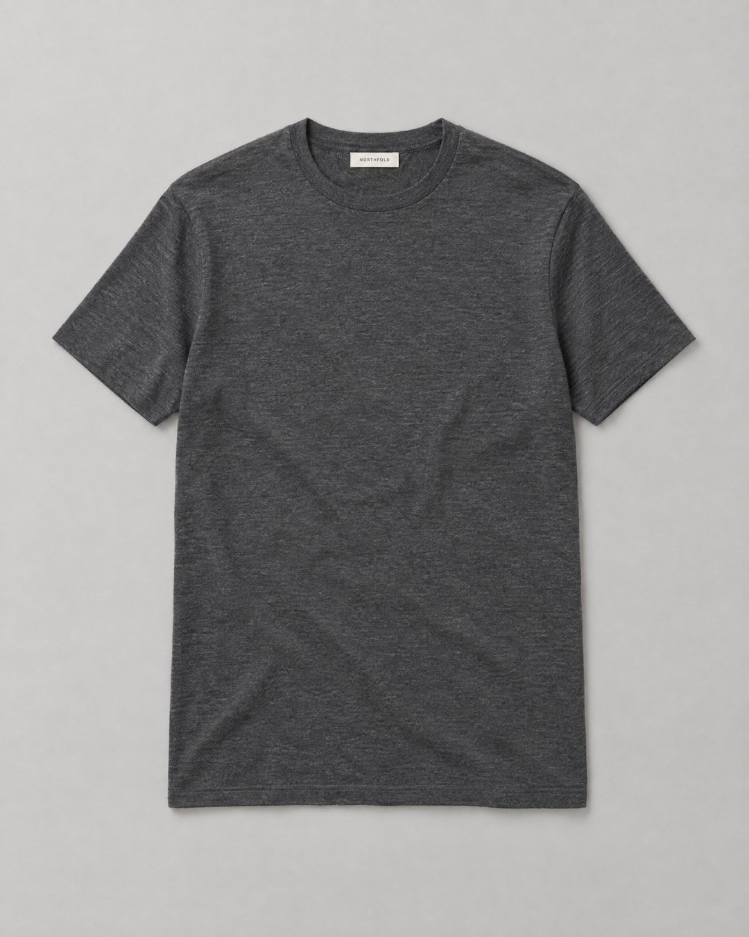 The Northfold 7-Day Tee, a charcoal merino T-shirt, laid flat